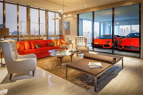 Luxury apartment living room with two supercars parked behind a glass wall at Sky Garage, Singapore
